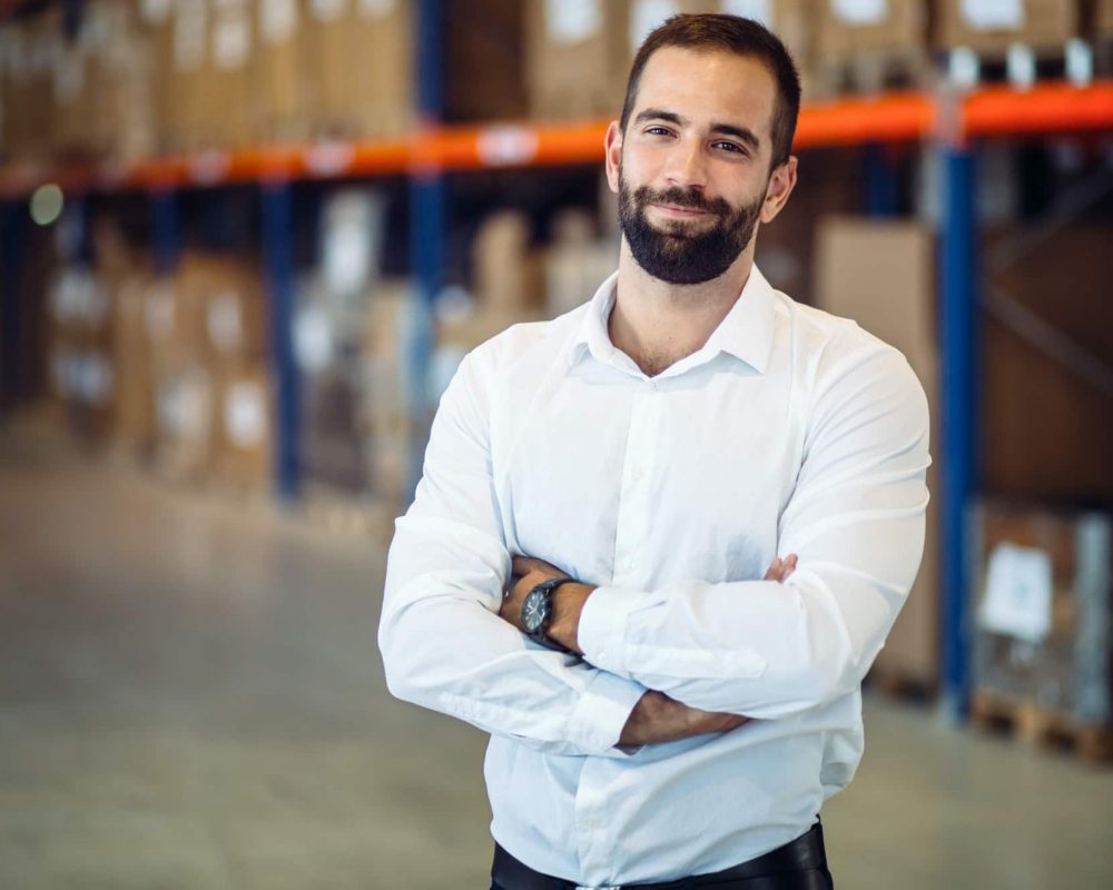 Logistics manager posing in warehouse